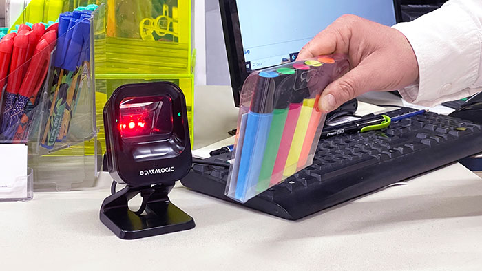 Customer using scanner at checkout